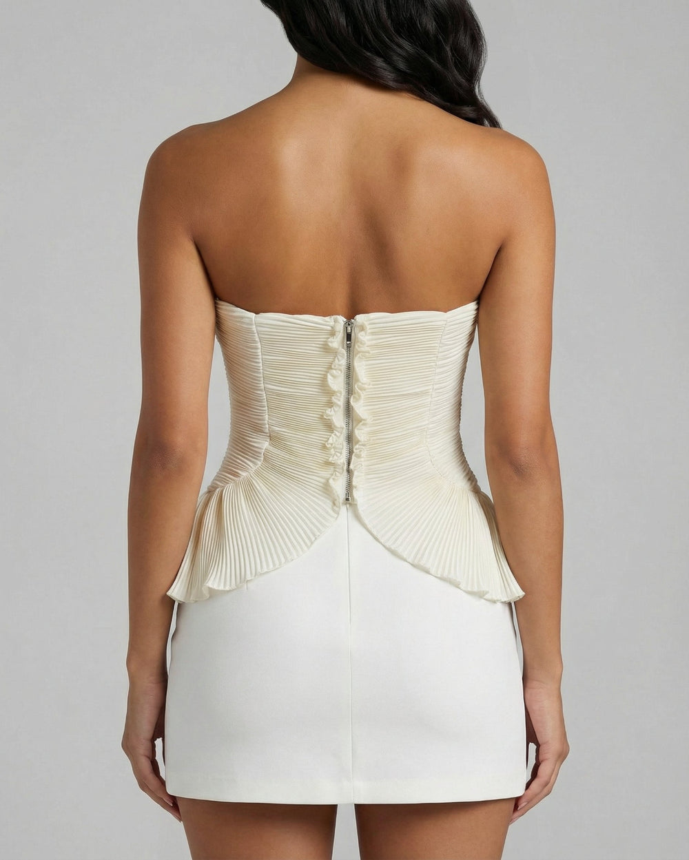 Back view of pleated strapless white bustier top