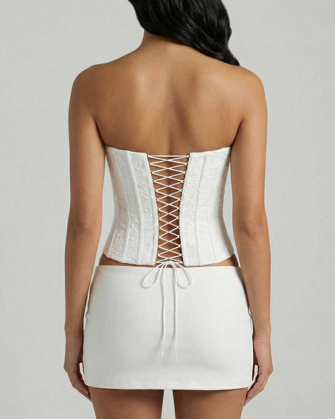 Back view of floral embroidered white corset top