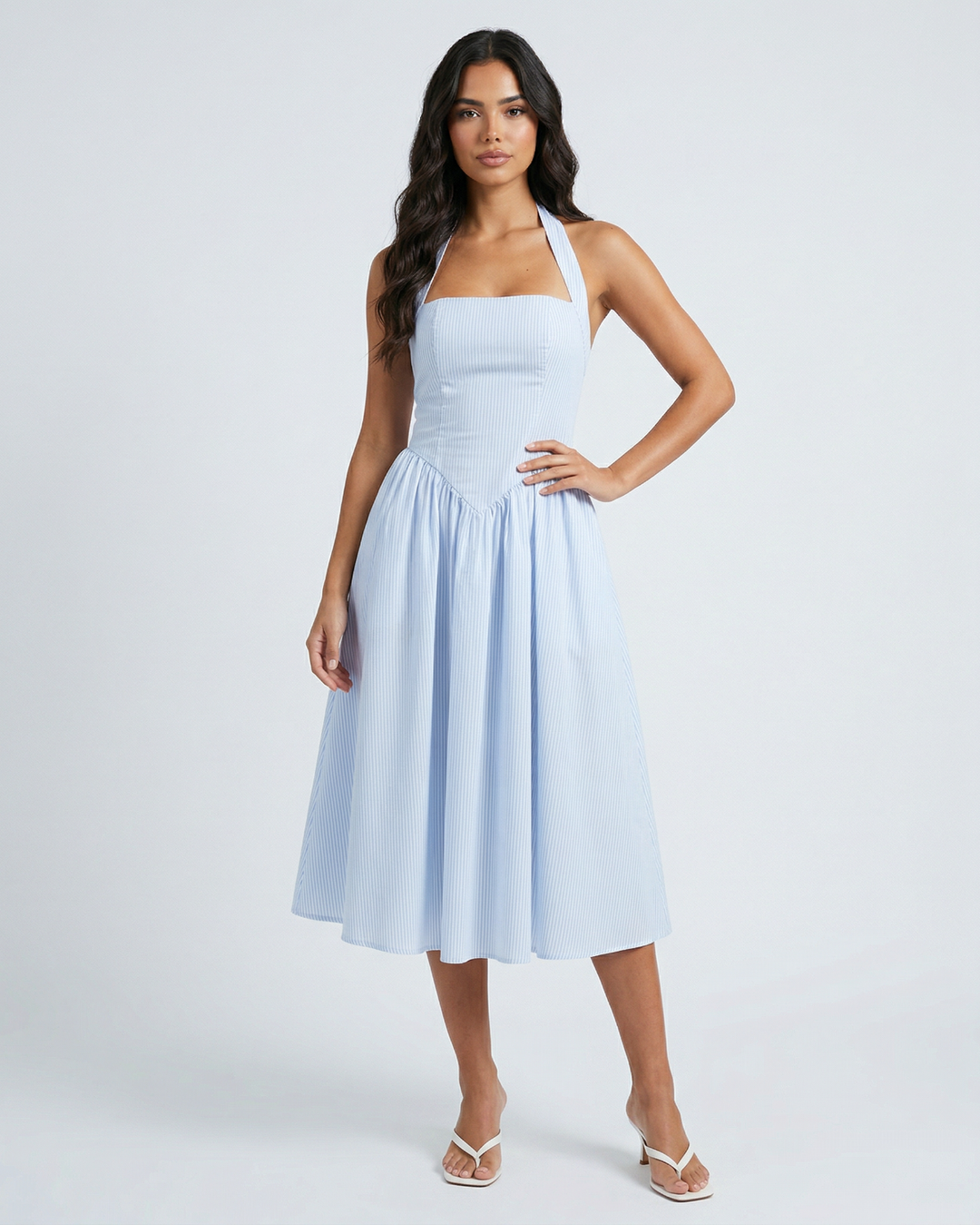 Woman wearing a light blue dress on a white background