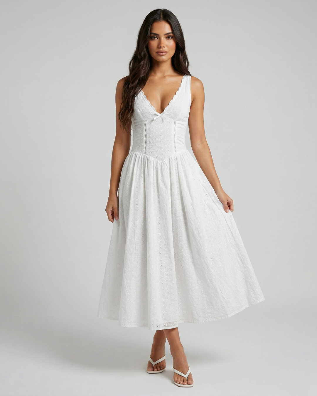 Woman wearing a white dress on a plain background